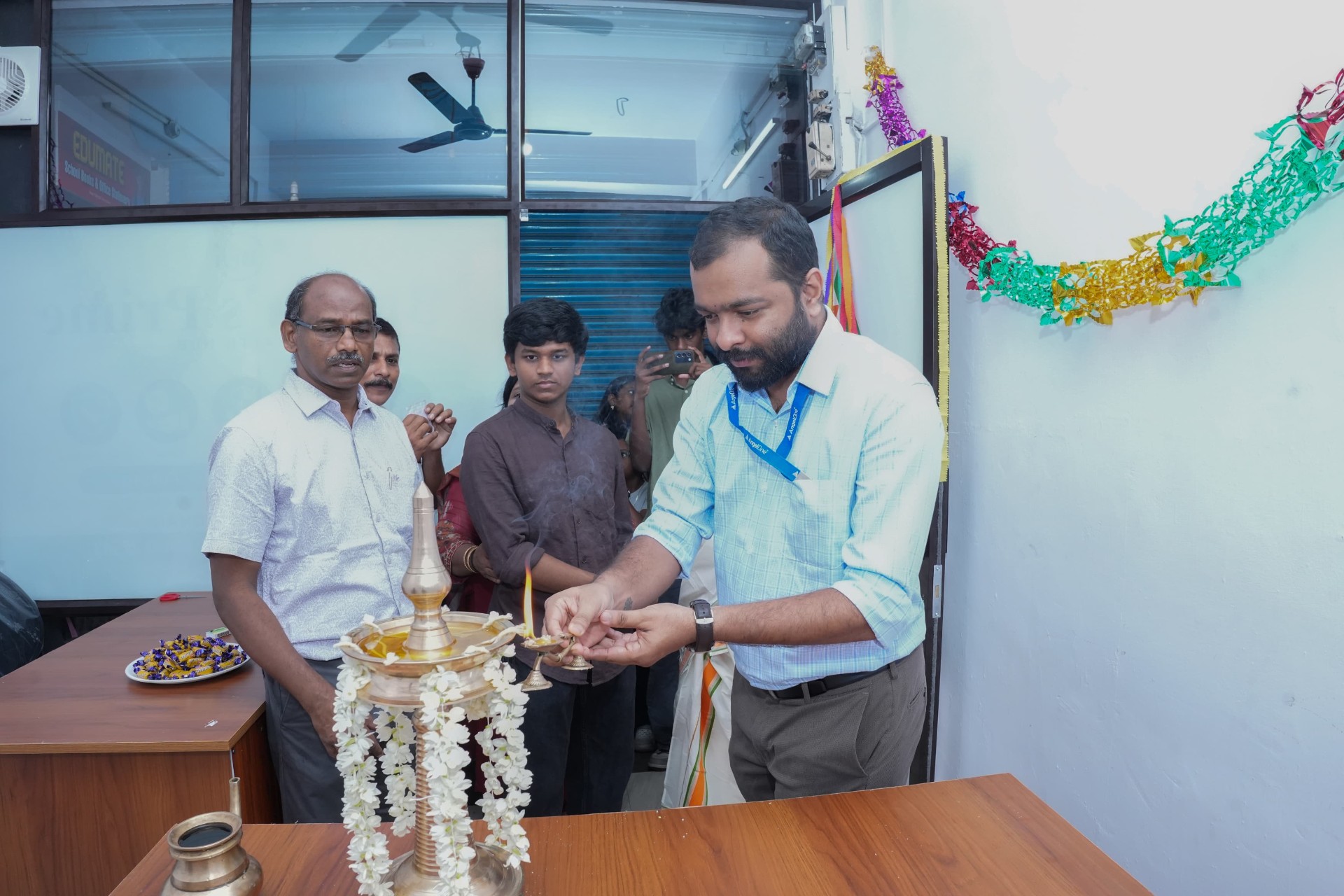 Lighting the traditional lamp to inaugurate the new office